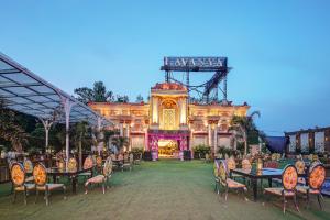 an outdoor dining area with tables and chairs in front of a building at Lavanya Hotel- Near Alipur, Delhi in New Delhi