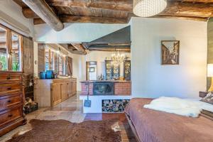 a bedroom with a large bed and a fireplace at Villa São Jorge in São Jorge