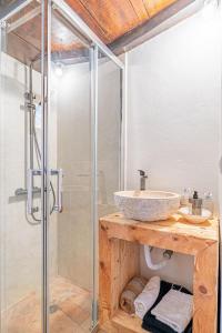 a bathroom with a sink and a glass shower at Villa São Jorge in São Jorge