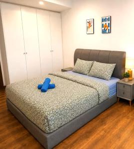 a bedroom with a bed with a blue object on it at Jazz Suite Vivacity Kuching in Kuching