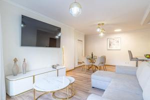 a living room with a couch and a table at Sunflower Apartment in Caniço
