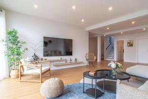a living room with a large tv on the wall at Isaq Villa in Santa Cruz in Gaula
