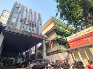 a group of motorcycles parked in front of a building at Alltrue Lite Senen Jakarta in Jakarta
