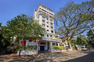 a tall white building on the corner of a street at Hotel Karl Residency in Mumbai