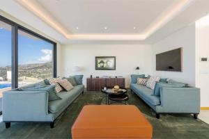 a living room with two couches and a tv at Celeste Villa in Ribeira Brava