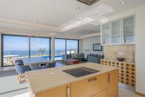a kitchen and living room with a view of the ocean at Celeste Villa in Ribeira Brava