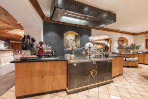 a kitchen with a large island in a room at Hotel Sonne Ischgl in Ischgl