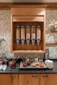 a kitchen with a counter with some food in a cabinet at Hotel Sonne Ischgl in Ischgl +119 photos