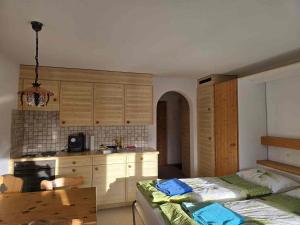 a kitchen with a bed and a table in a room at ELAfora Studio in Salouf +16 photos