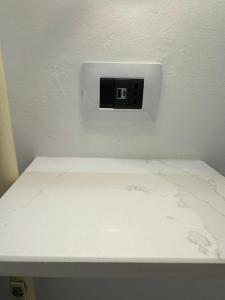 a white counter with a lightswitch on a wall at Core Salentino Rooms in Campomarino