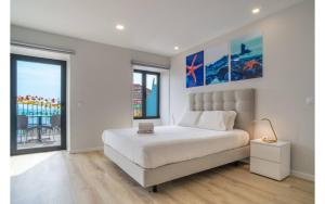 a bedroom with a bed with a laptop on it at Jardim Mar Flats in Jardim do Mar
