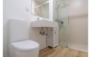 a bathroom with a toilet and a sink and a shower at Jardim Mar Flats in Jardim do Mar +33 photos