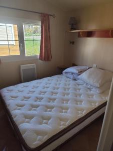 a large white bed in a bedroom with a window at San gavino in Savines