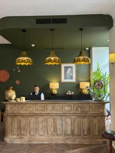 a man sitting at a bar in a restaurant at Hotel La Villa Nice Victor Hugo in Nice