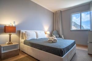 a bedroom with a bed with a stuffed animal on it at Front beach Apartment in Paul do mar 9 in Paul do Mar