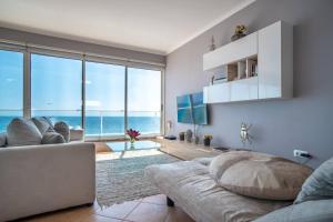 a living room with a couch and a view of the ocean at Front beach Apartment in Paul do mar 9 in Paul do Mar