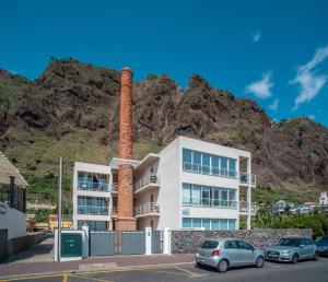 a apartment building with a mountain in the background at Front beach Apartment in Paul do mar 9 in Paul do Mar