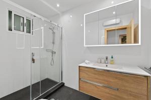 a white bathroom with a shower and a sink at Florentina Villa in Gaula +63 photos