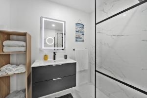 a white bathroom with a sink and a shower at Casa da Telvina in Paul do Mar +15 photos