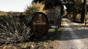 a wooden barrel sitting on the side of a road at Il Giuncheto in Trequanda