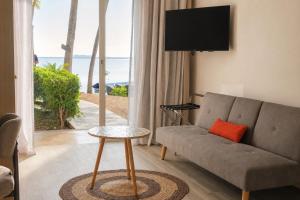 a living room with a couch and a table at Lankraz Hotel Mauritius in Port Louis