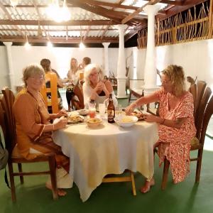 a group of women sitting at a table at Talalla Mango House in Talalla South