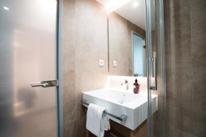 a bathroom with a white sink and a shower at Hotel Kapuzinerhof in Biberach an der Riß +41 photos