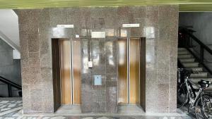 two elevators on the side of a building at Apartamentai Vanagupės banga in Palanga