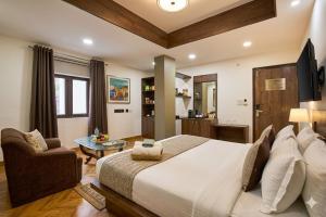 a large bedroom with a large bed and a chair at Hotel Anand - Near Ganga Ram & BLK Hospital At Karol Bagh Metro Station in New Delhi