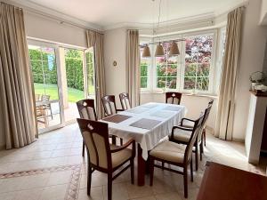 a dining room with a table and chairs at Baltic Garden Villa in Gdynia