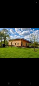 a large building in the middle of a field at Shepherd Hutten Hunsel in Hunsel