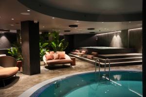a hotel lobby with a hot tub and a relaxation room at Clarion Hotel The Hub in Oslo