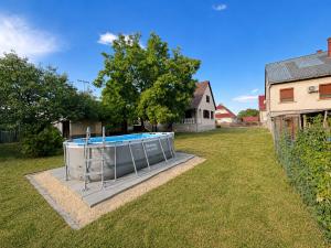 a swimming pool in the middle of a yard at Retro Land Bogács in Bogács