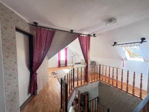 a staircase in a house with red curtains at Retro Land Bogács in Bogács