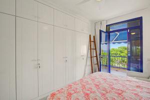 a bedroom with a bed and a door to a balcony at Bungalow meloneras in San Bartolomé +20 photos
