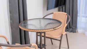 a glass table and a chair on a balcony at E7 YangYang Jukdo - Yangyang Stay Dongsan in Saetchak
