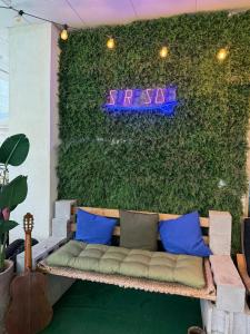 a couch sitting in front of a green wall at Yangyang Kai Guesthouse Surf in Yangyang
