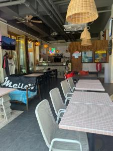 a dining room with tables and chairs in a restaurant at Yangyang Kai Guesthouse Surf in Yangyang +29 photos