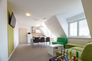 a living room with a green couch and a table at Apartments Hradný Mur in Bojnice