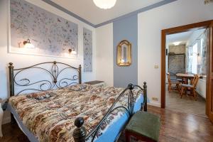 a bedroom with a bed and a dining room at Apartments Hradný Mur in Bojnice
