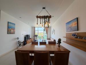 a dining room and living room with a table and chairs at Ocean Vista Mai House in Ấp Phú Tịnh (2)