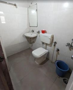 a bathroom with a toilet and a sink and a mirror at Hotel Sai Leela in Amarnāth