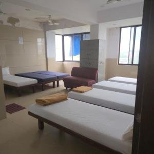 a room with several beds and chairs in it at Hotel Sai Leela in Amarnāth +13 photos