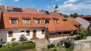 a large house with an orange tile roof at Apartments Hradný Mur in Bojnice
