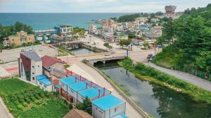 an aerial view of a town with a river at Samcheok Healingcamp Pension in Samcheok