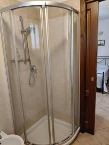 a shower with a glass door in a bathroom at Agriturismo Pettinari in Marina di Grosseto