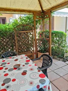a table and two chairs sitting under a pergola at Agriturismo Pettinari in Marina di Grosseto +63 photos