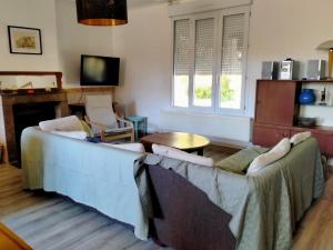 a living room with a couch and a table at La maison de Claudine in Bergues
