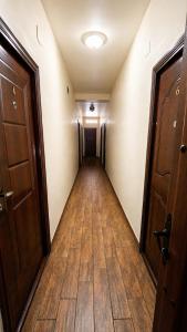 an empty hallway with a long hall with wooden floors at Crama Tărănească in Tătărani