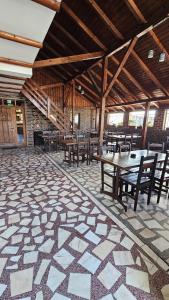 a dining room with tables and chairs in a building at Crama Tărănească in Tătărani